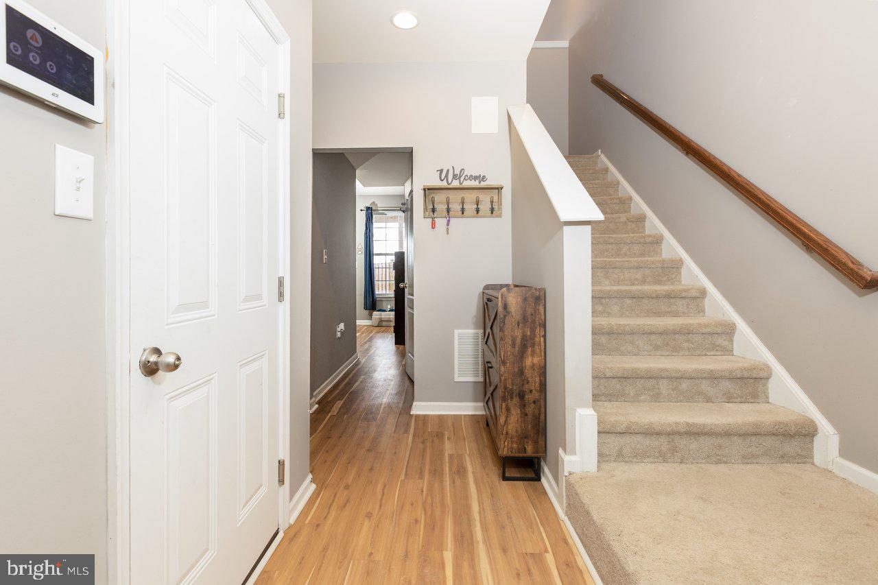 47 Landis Court Falling Waters, WV 25419 - Photo 6 of 35 a view of a hallway with wooden floor and entryway