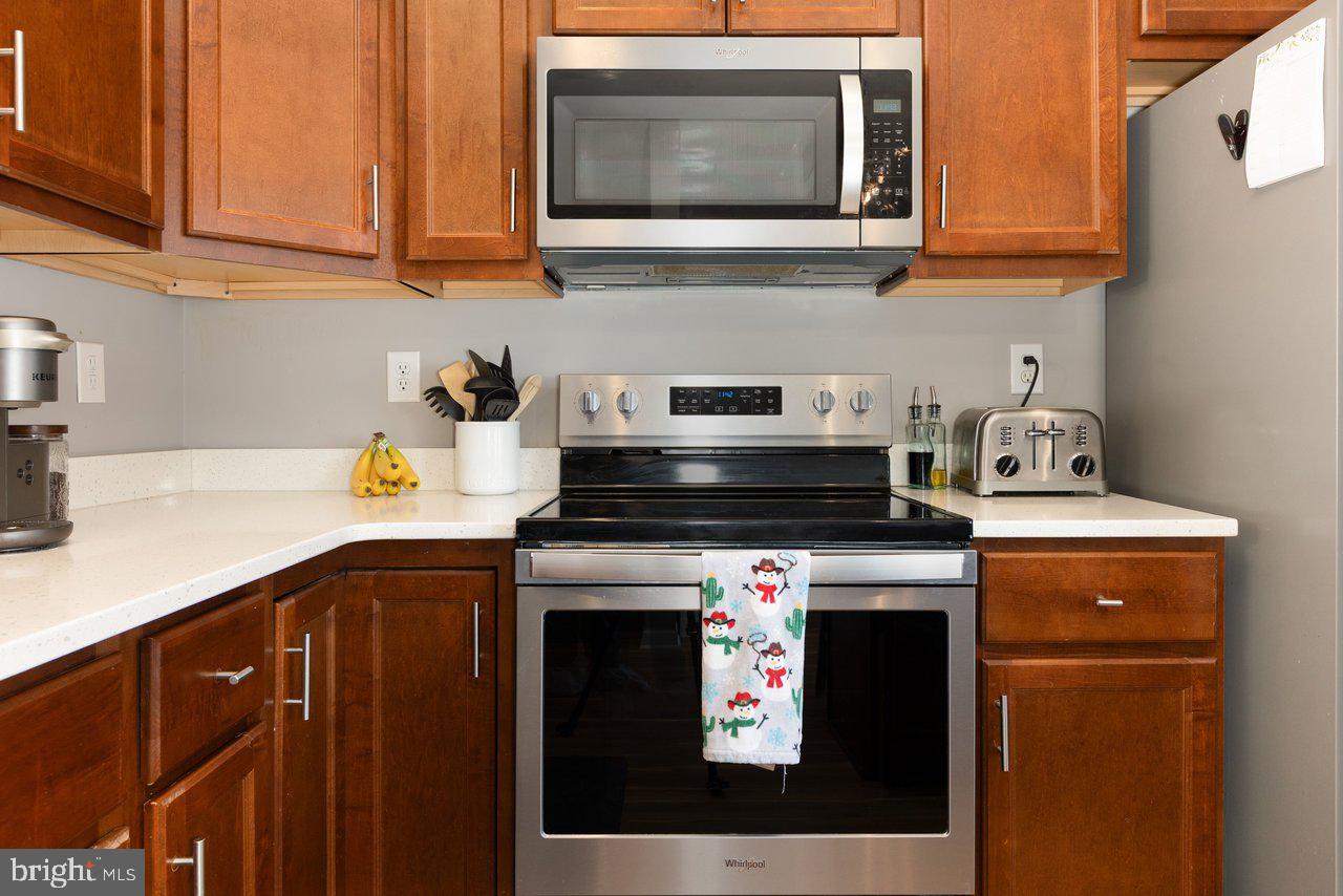 47 Landis Court Falling Waters, WV 25419 - Photo 10 of 35 a kitchen with stainless steel appliances granite countertop a stove a sink and a microwave