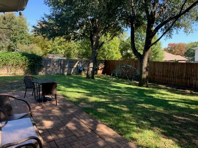 a view of a backyard with a sitting area