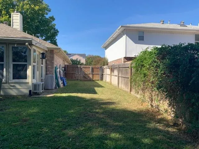 a view of house with backyard
