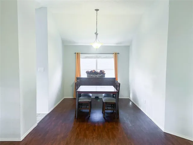 a dining room with furniture window and wooden floor