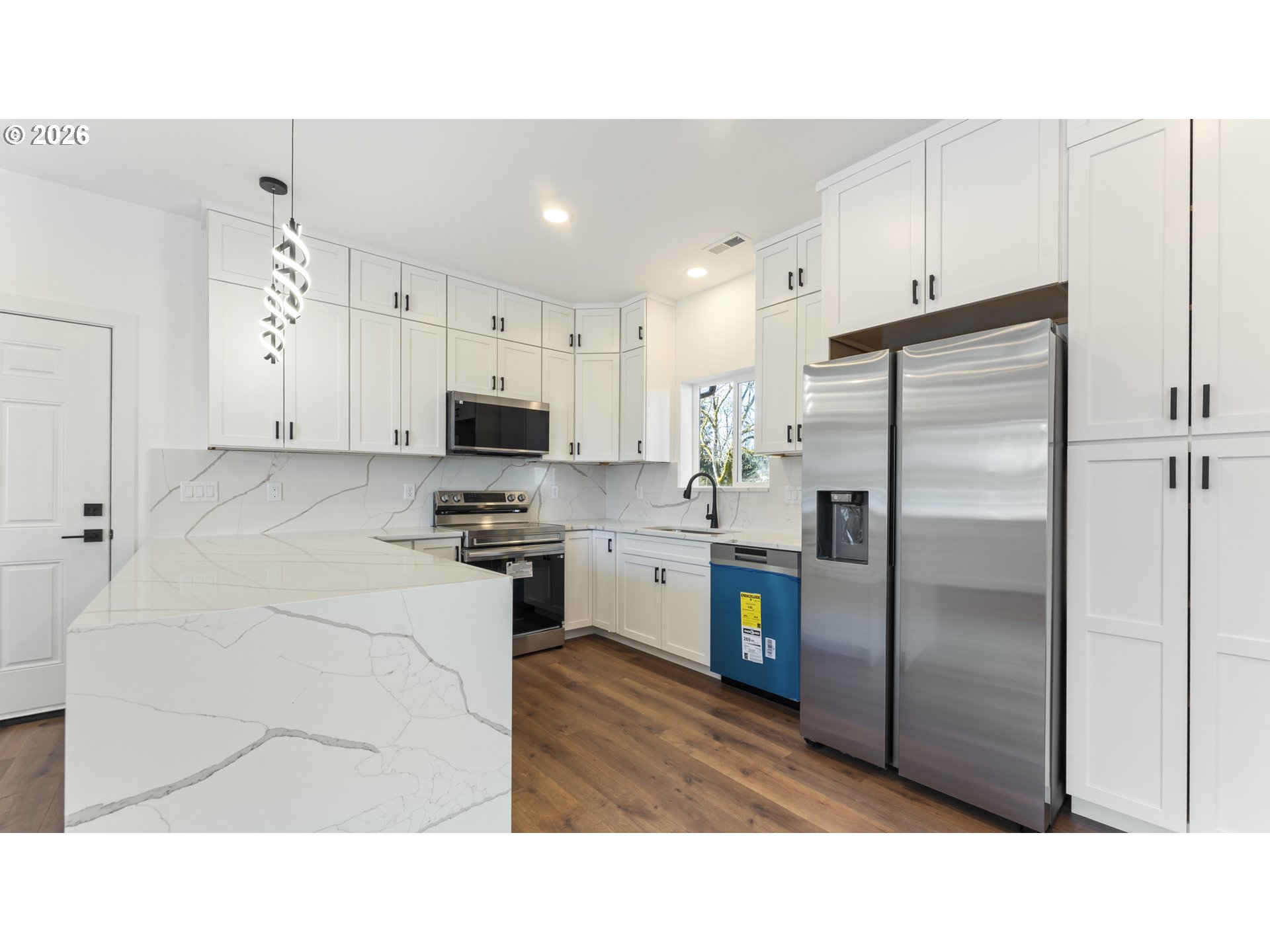 141 Northeast D Street Willamina, OR 97396 - Photo 12 of 43 a kitchen with cabinets and stainless steel appliances