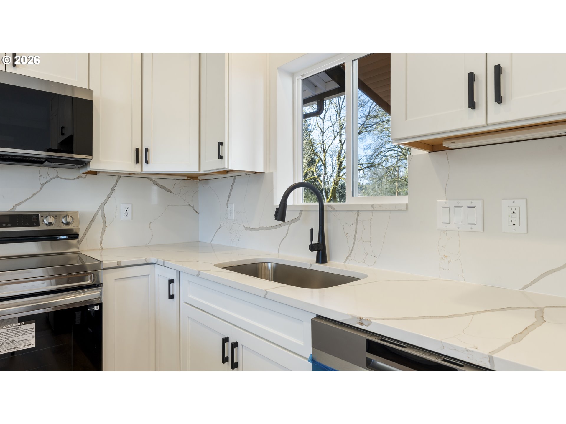 141 Northeast D Street Willamina, OR 97396 - Photo 13 of 43 a kitchen with a sink dishwasher and a stove with wooden floor