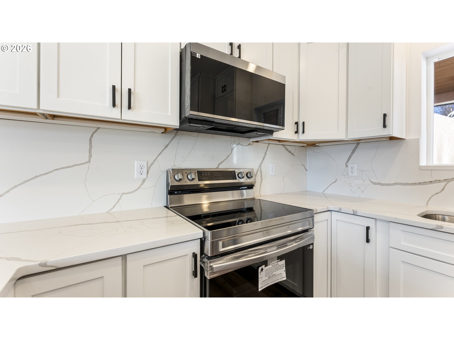 141 Northeast D Street Willamina, OR 97396 - Photo 14 of 43 a kitchen with a sink and white cabinets