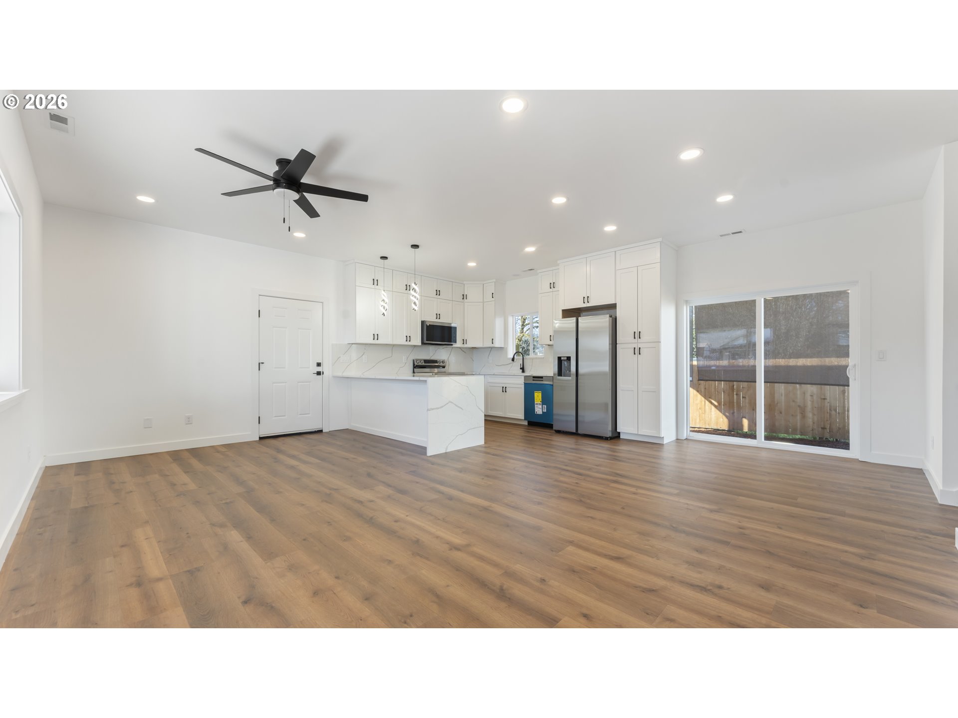 141 Northeast D Street Willamina, OR 97396 - Photo 5 of 43 a living room with stainless steel appliances kitchen island wooden floors