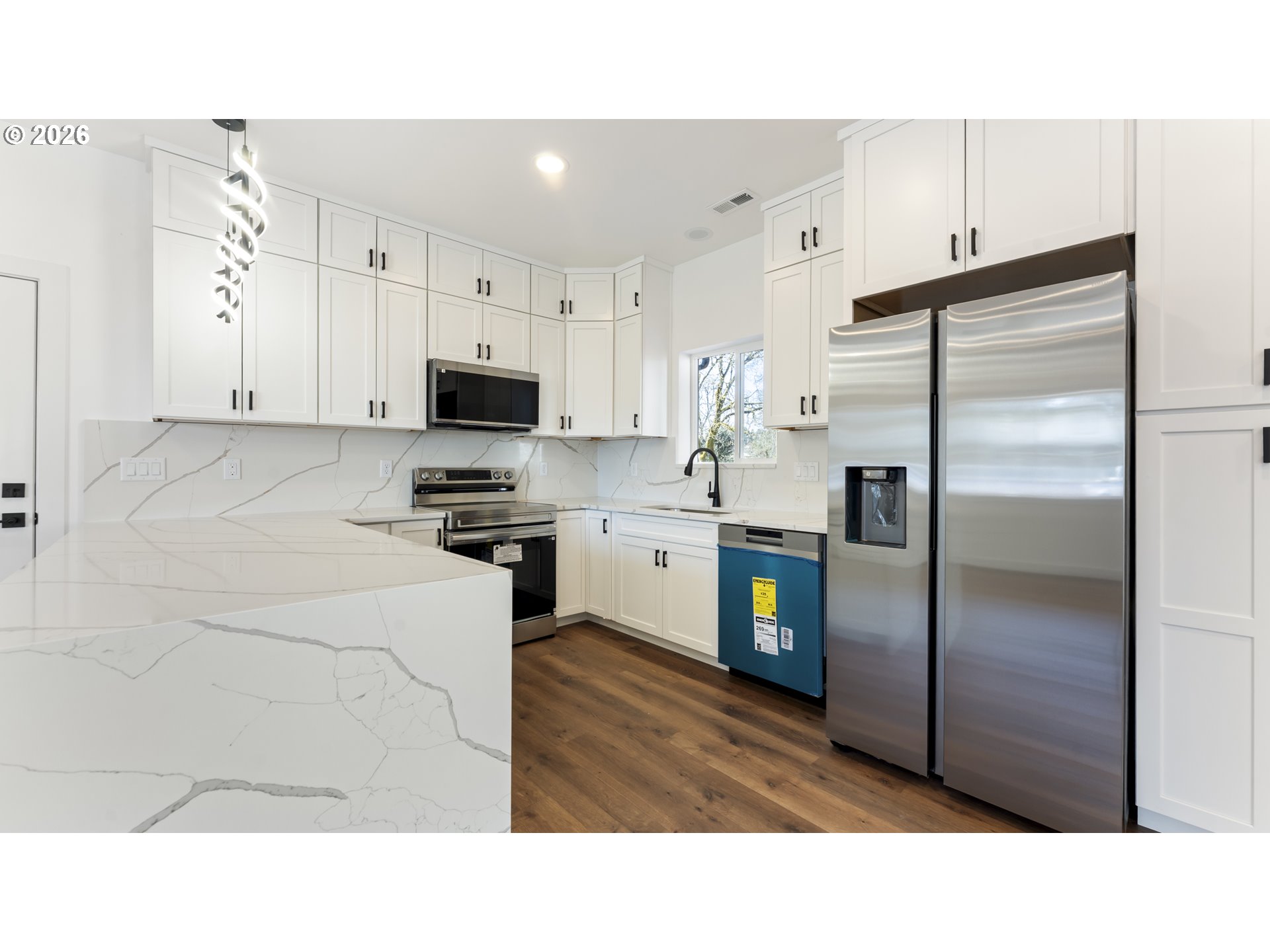 141 Northeast D Street Willamina, OR 97396 - Photo 9 of 43 a kitchen with cabinets and stainless steel appliances