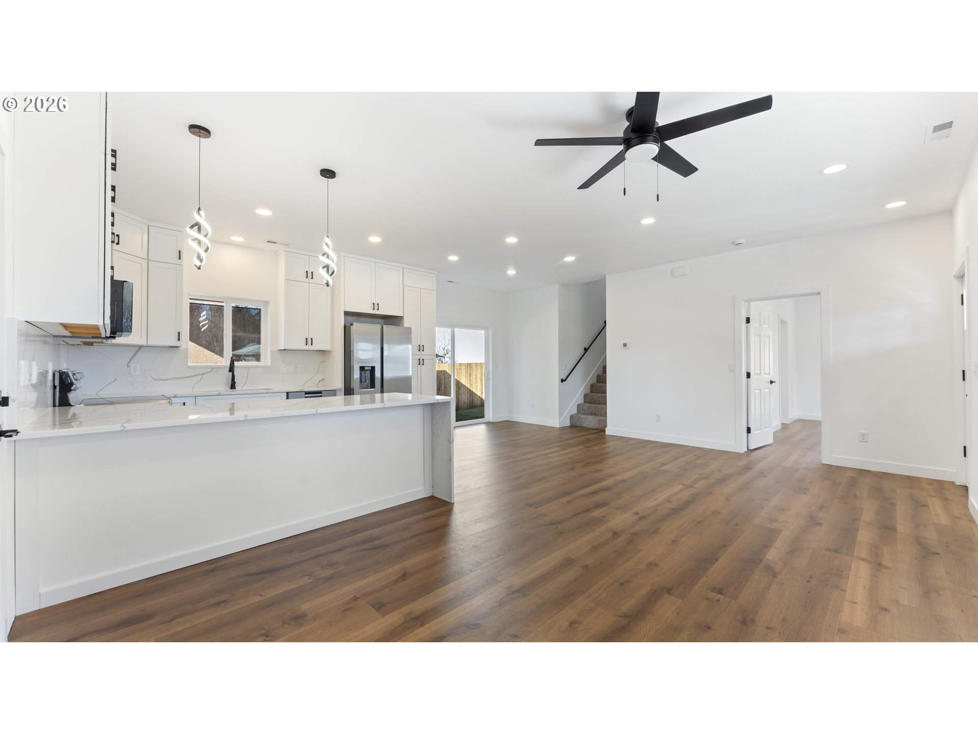141 Northeast D Street Willamina, OR 97396 - Photo 10 of 43 a living room with kitchen island furniture and a ceiling fan