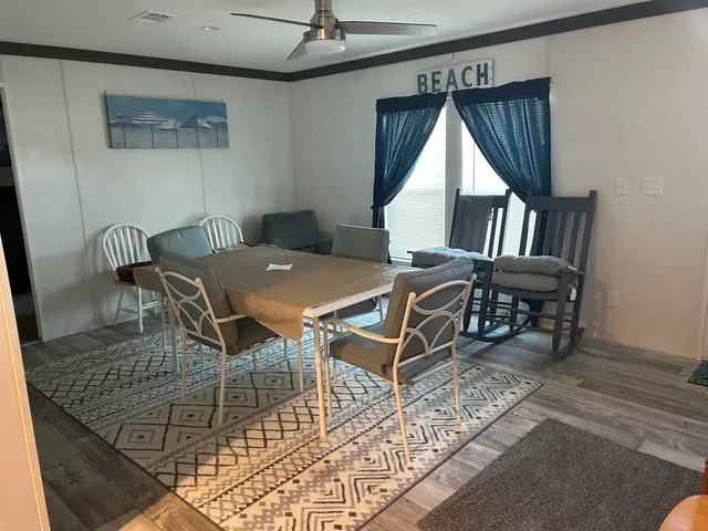 a view of a dining room with furniture and window