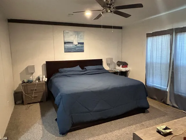 a bedroom with a bed and window