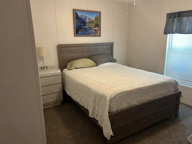 a bedroom with a bed and wall painting