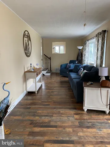 a living room with furniture and a mirror