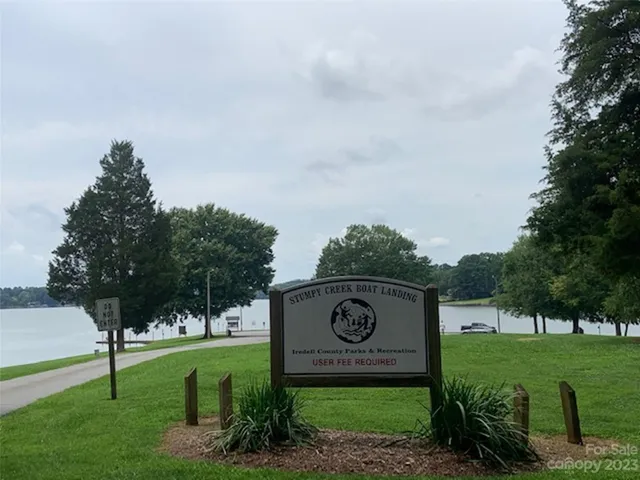 a view of a park with a bench and trees