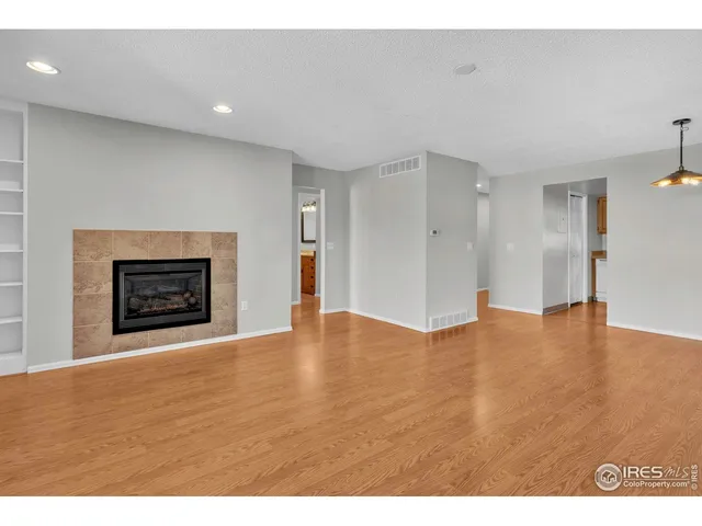 a view of an empty room with a fireplace