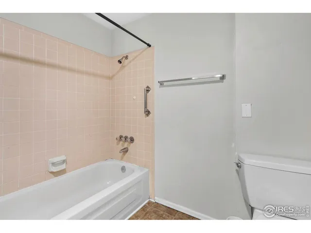 a bathroom with a tub and a shower