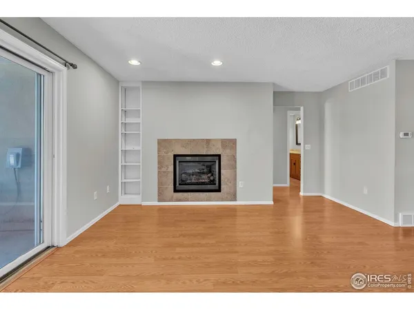 a view of an empty room with a fireplace