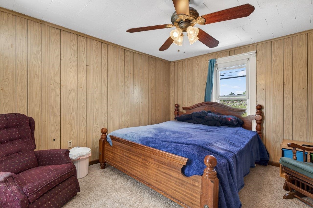 724 Newtown Road Elkton, VA 22827 - Photo 22 of 38 a bedroom with a bed and a chandelier