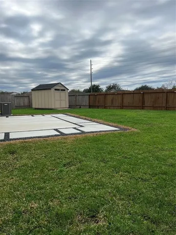 a view of yard with swimming pool and green space
