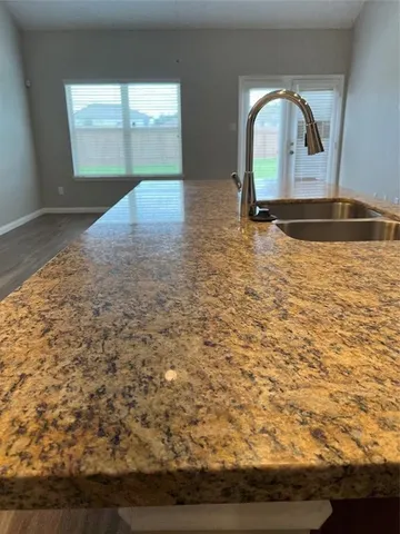 a view of a livingroom with wooden floor and a large window