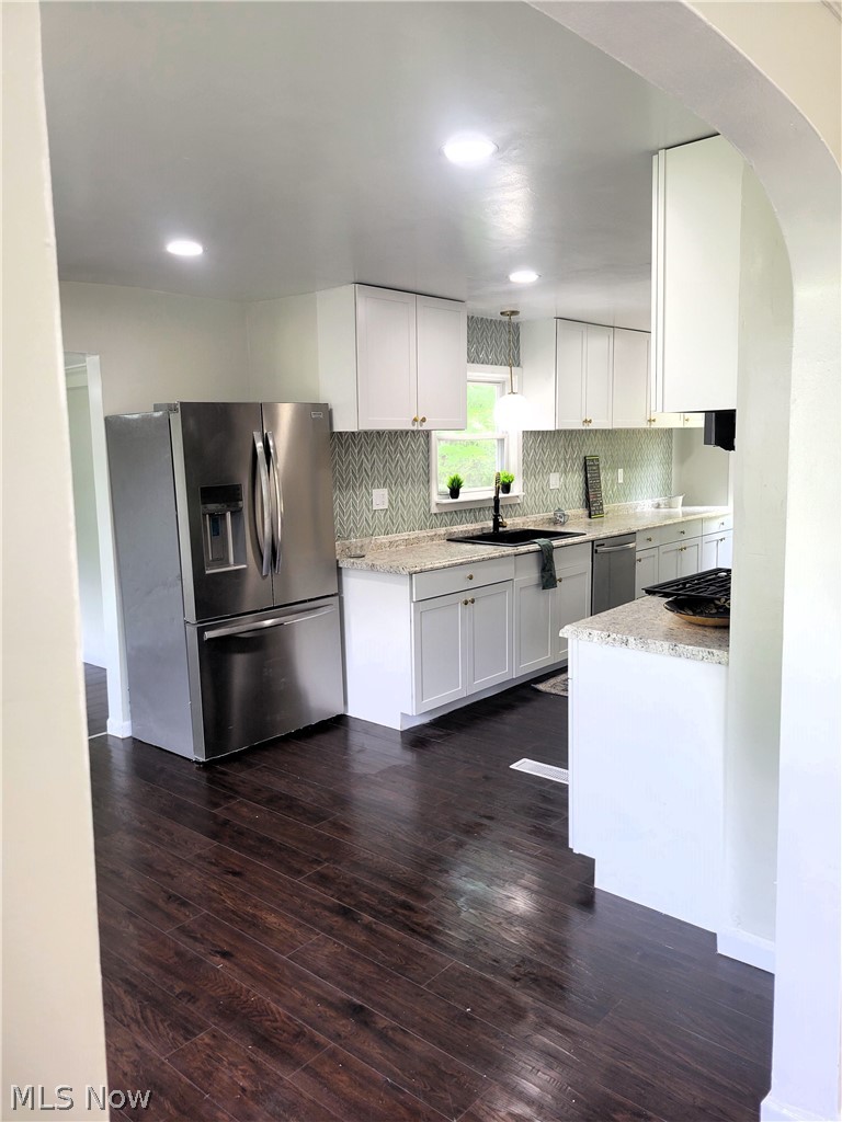 1557 Maplegrove Road South Euclid, OH 44121 - Photo 11 of 23 Kitchen with white cabinets, sink, dark hardwood / wood-style flooring, and stainless steel appliances