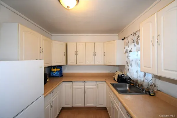 a kitchen with a sink a stove and cabinets