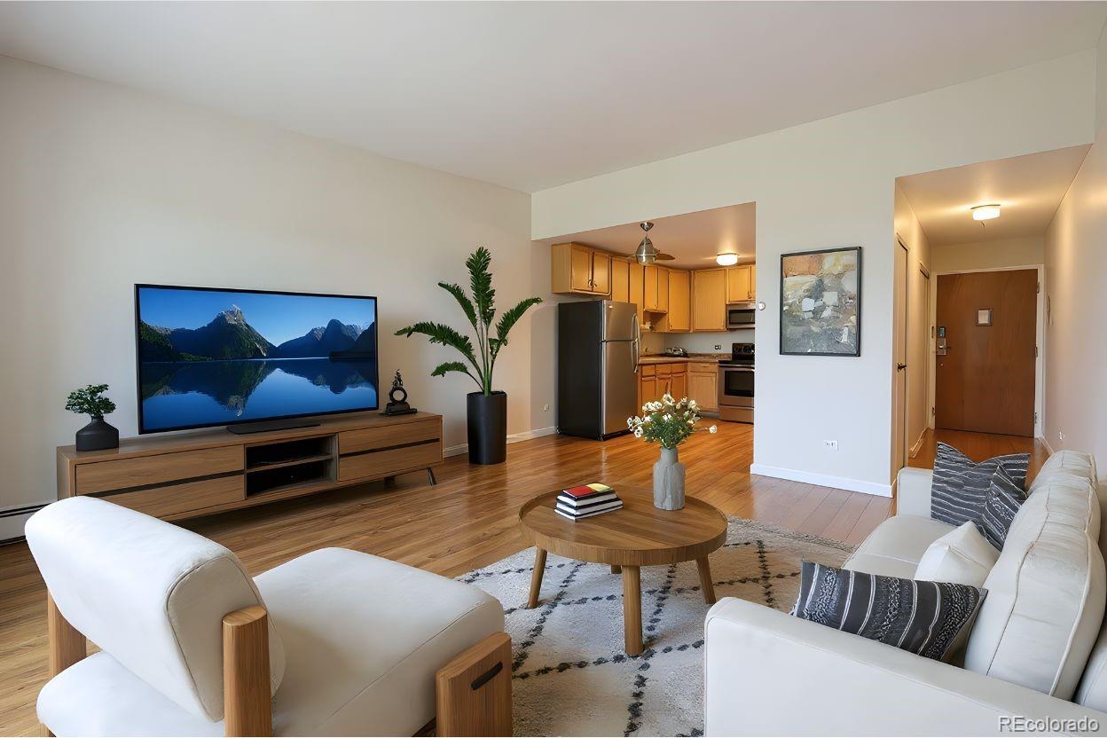 a living room with furniture and wooden floor