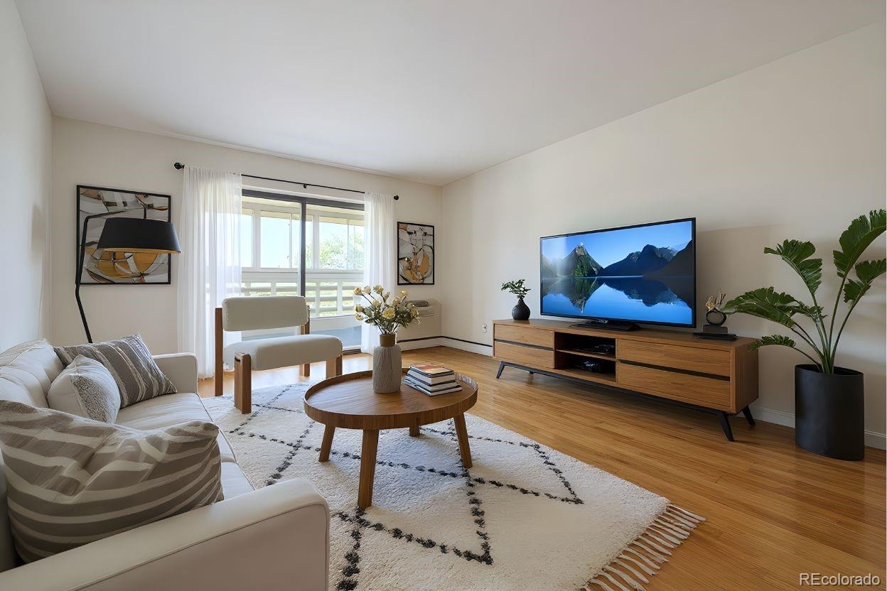 9155 Center Avenue, Unit 2D Denver, CO 80247 - Photo 2 of 50 a living room with furniture and a potted plant