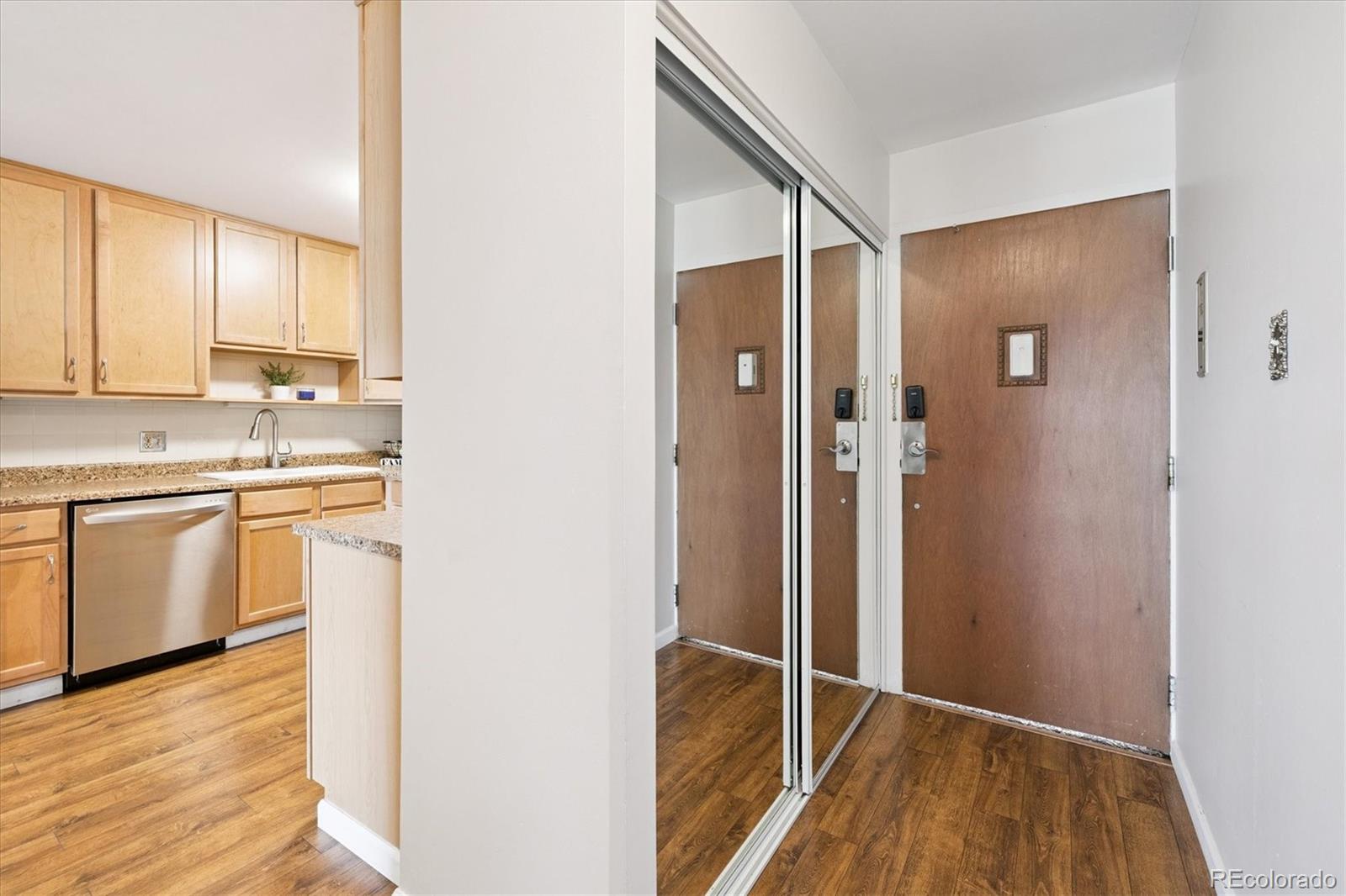 9155 Center Avenue, Unit 2D Denver, CO 80247 - Photo 7 of 50 a kitchen with white cabinets and white appliances
