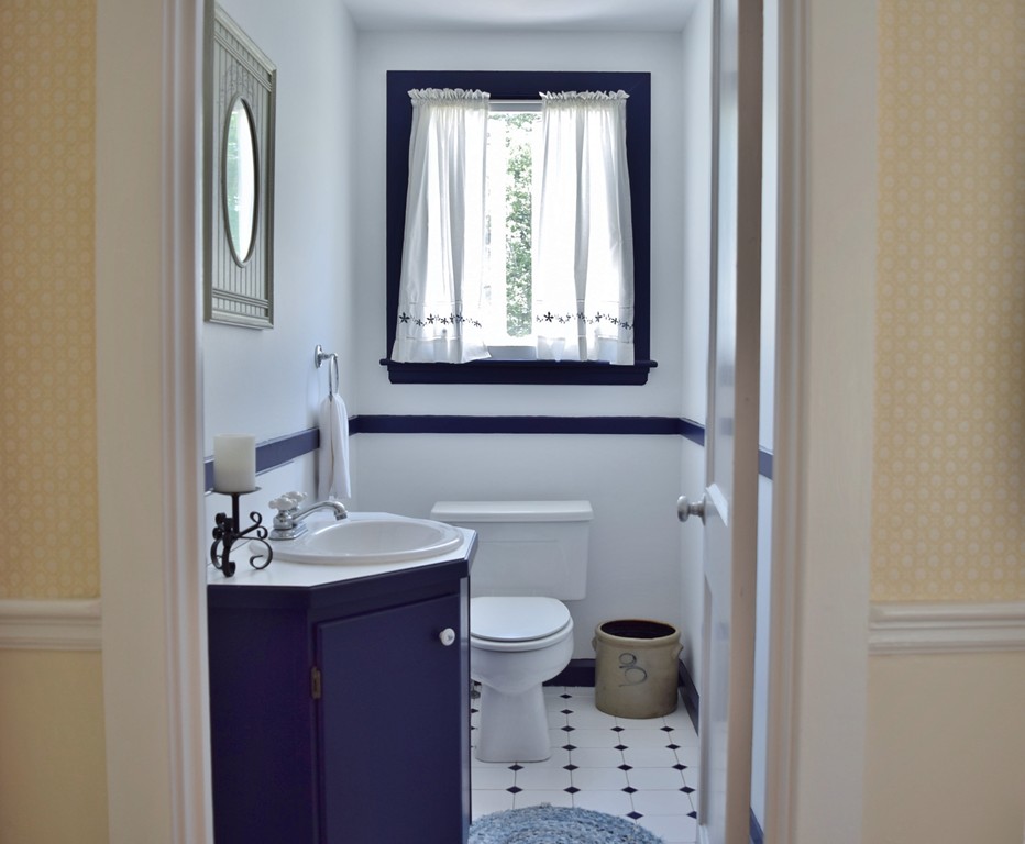 309 Red Acre Road Stow, MA 01775 - Photo 7 of 26 a bathroom with a sink a toilet and a mirror