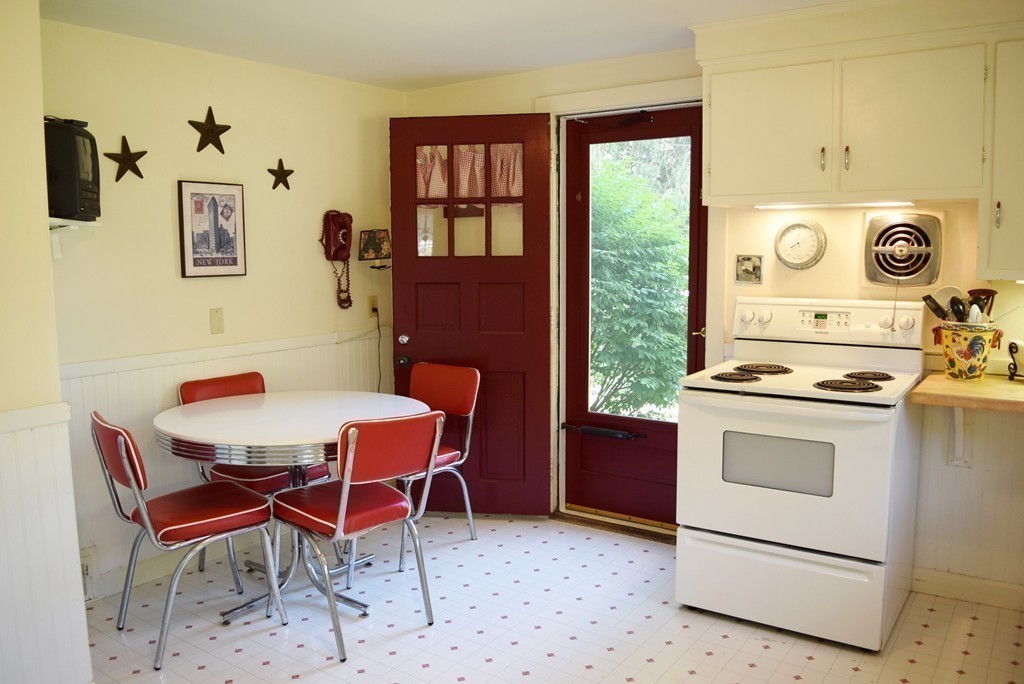 309 Red Acre Road Stow, MA 01775 - Photo 9 of 26 a dining room with a stove a sink and a refrigerator