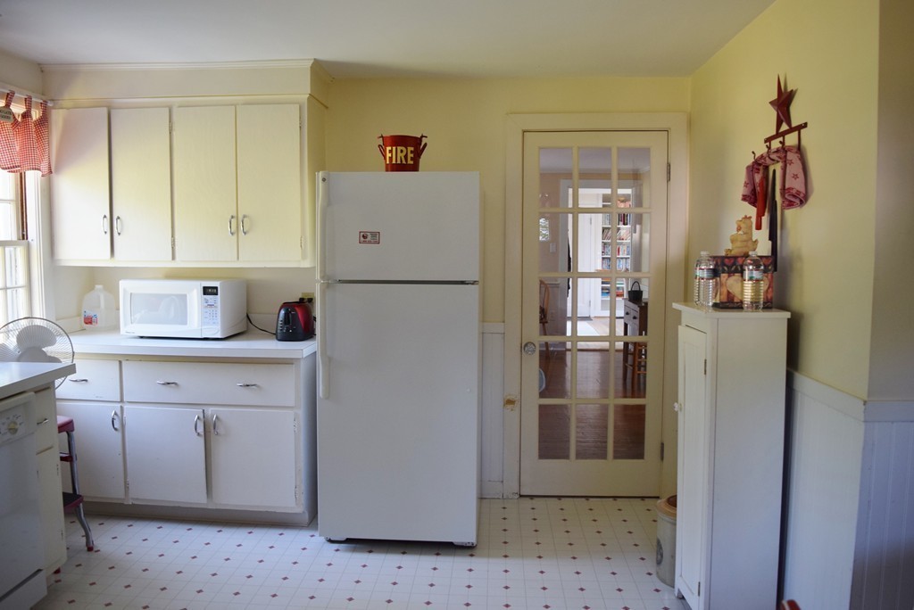 309 Red Acre Road Stow, MA 01775 - Photo 10 of 26 a kitchen with a refrigerator and a sink