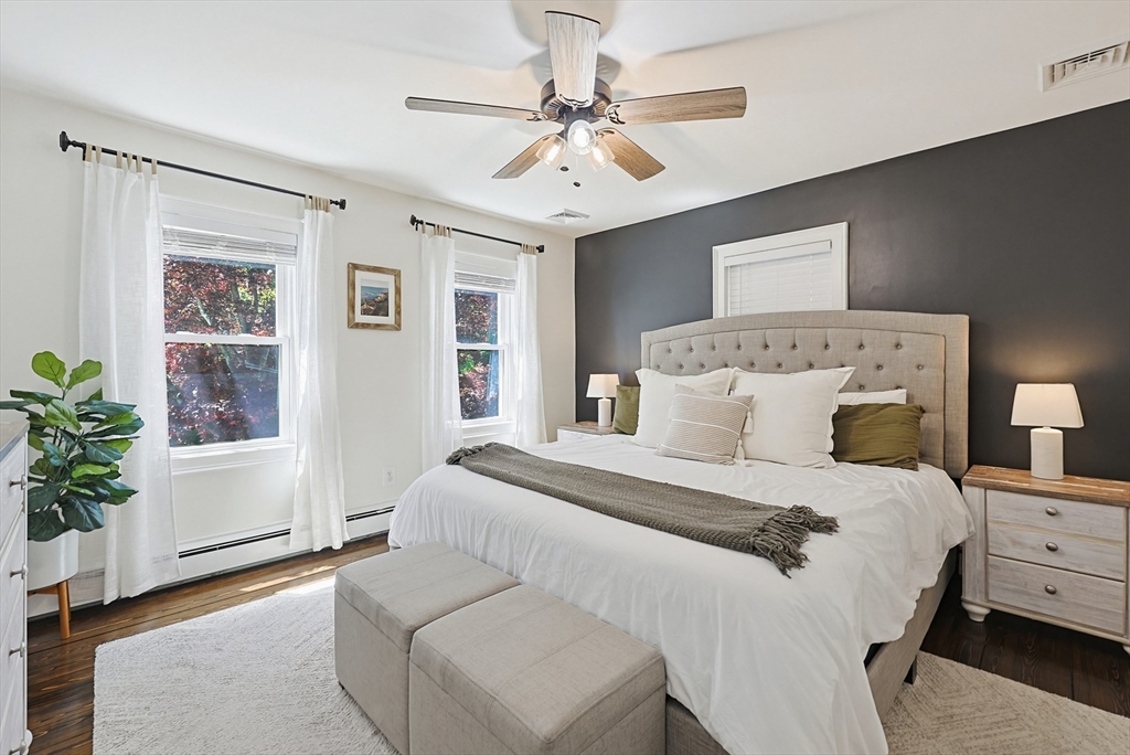 345 Sherman Street Canton, MA 02021 - Photo 19 of 42 a bedroom with a large bed and a chandelier fan