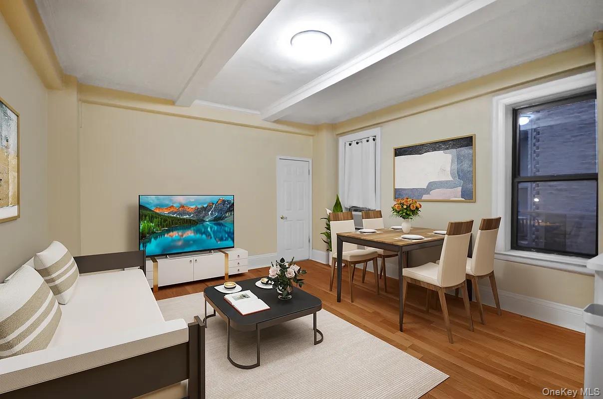 17 West 64th Street, Unit 1D Manhattan, NY 10023 - Photo 4 of 7 a living room with furniture and a flat screen tv