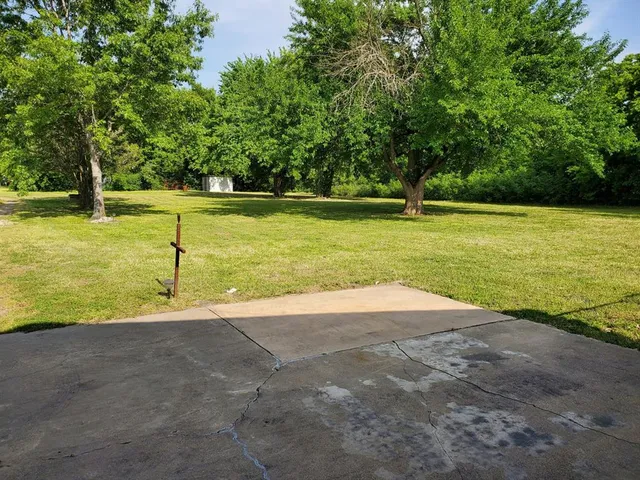 a view of a swimming pool with a yard