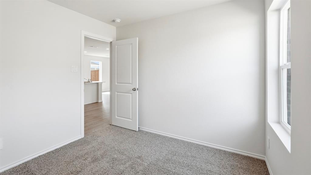 3319 Twilight Trail Forney, TX 75126 - Photo 22 of 33 Carpeted room with white walls, a white trim baseboard, and a white window frame