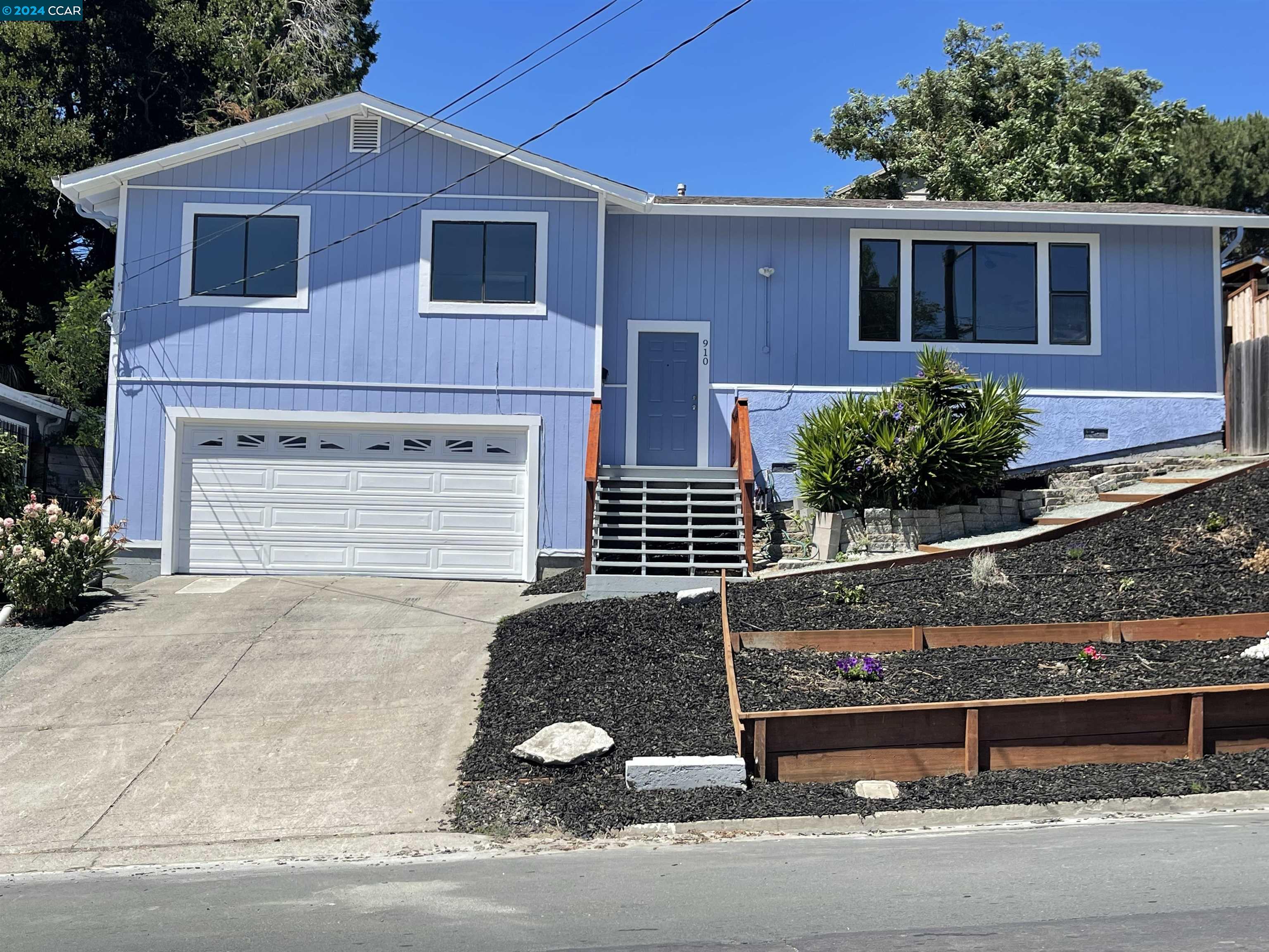 910 Mariposa Street Rodeo, CA 94572 - Photo 1 of 1 a front view of a house with garage
