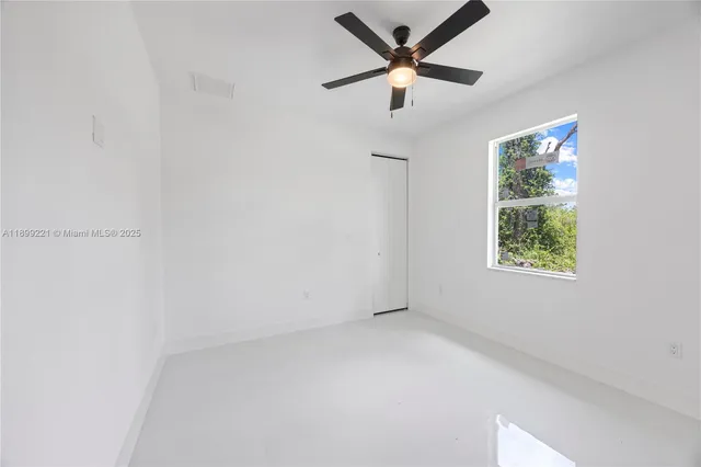 a view of a livingroom with a ceiling fan and a window