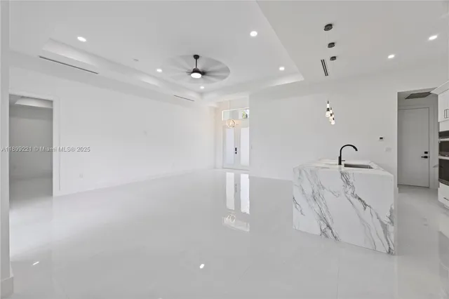 a view of a kitchen with a sink and dishwasher a refrigerator with wooden floor