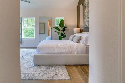 a spacious bedroom with a large bed and a large window