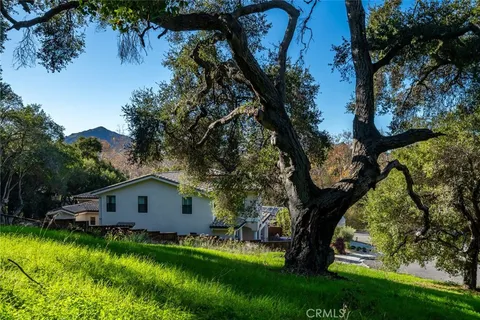 a view of house with backyard and garden