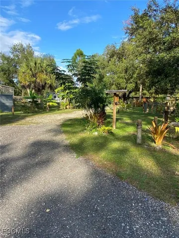 a view of yard with swimming pool and trees