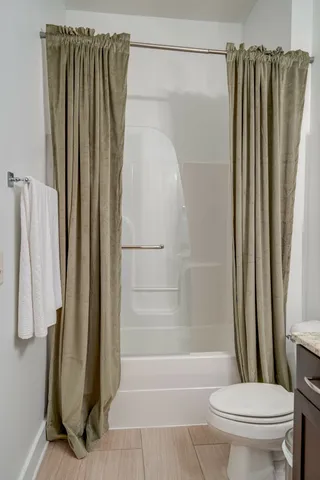 a bathroom with a shower and a toilet