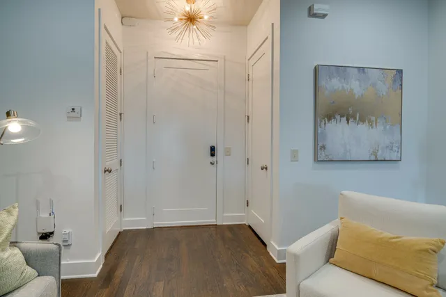 a view of a livingroom with a couch and a chandelier fan