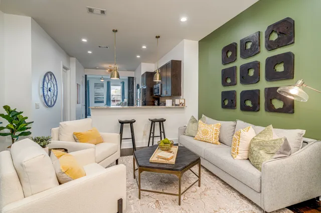 a living room with furniture and wooden floor