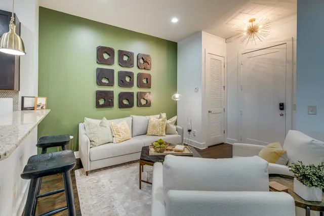 a living room with furniture and a potted plant