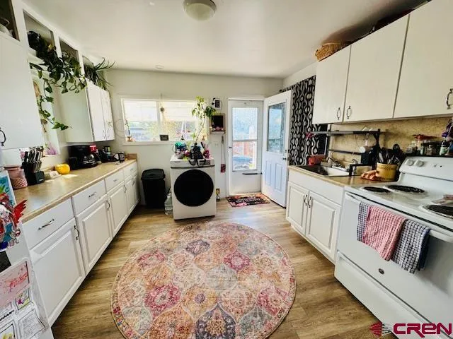 a kitchen with a stove a sink and a refrigerator