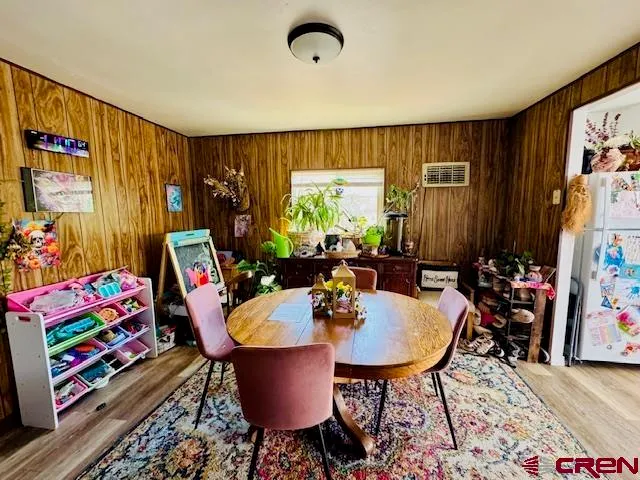 a dining room with furniture and a window