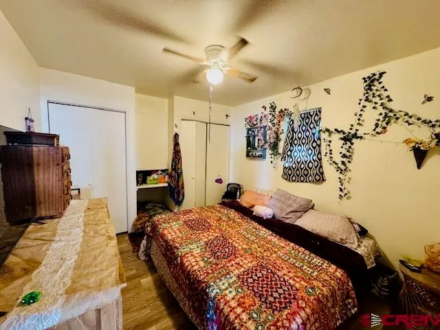 a bed sitting in a bedroom next to a window and a chandelier