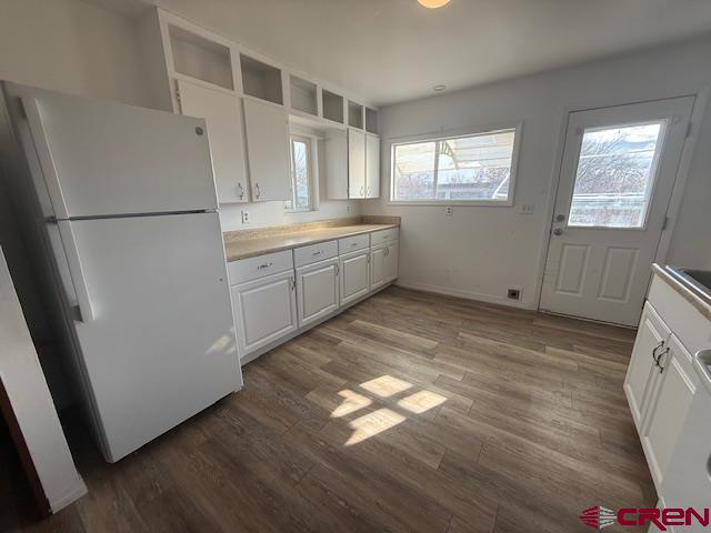 320 Southwest 8th Avenue Cedaredge, CO 81413 - Photo 10 of 18 a kitchen with white cabinets and white appliances