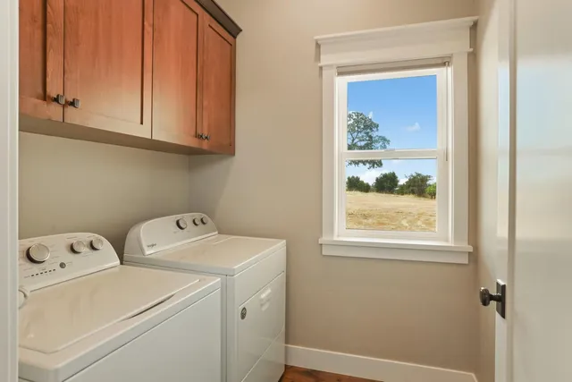 a bathroom with a granite countertop toilet a sink and mirror