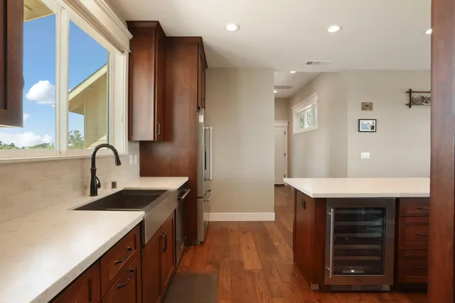 a bathroom with a granite countertop toilet a sink and mirror